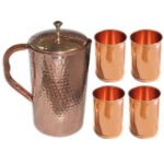 One Hammered Copper Jug And Four Plain Copper Glasses